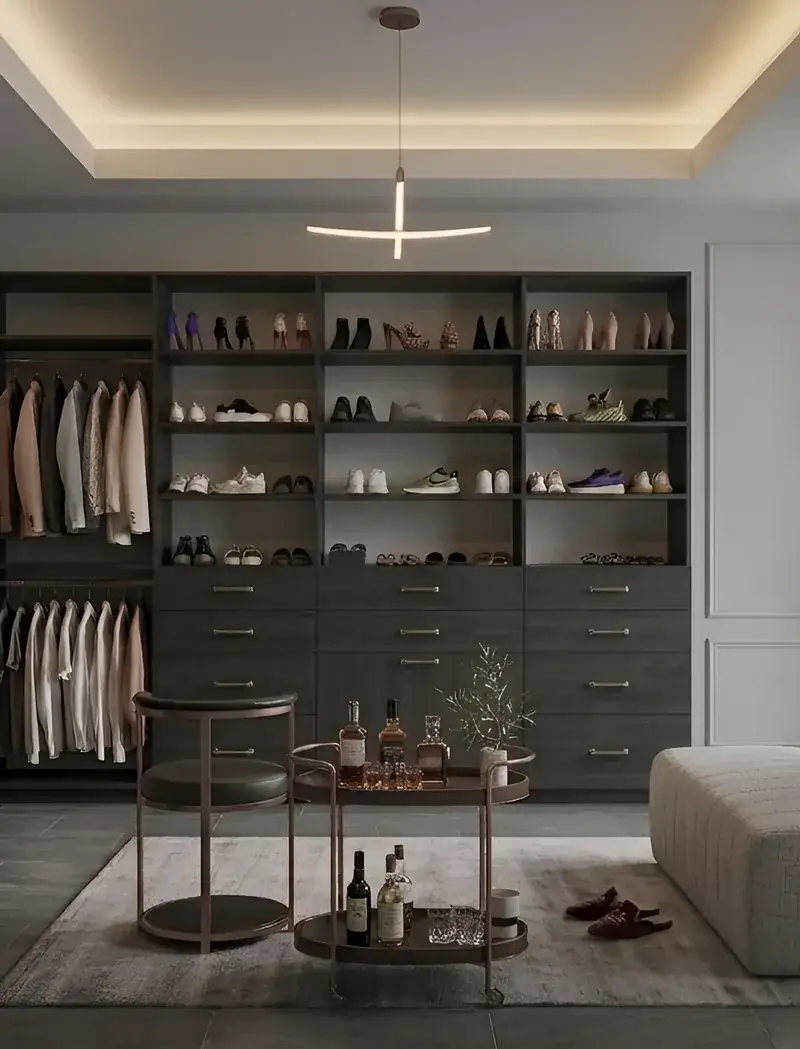 Walk-in closet with dark oak shelving, drawers and a shoe wall, built by Closet Form